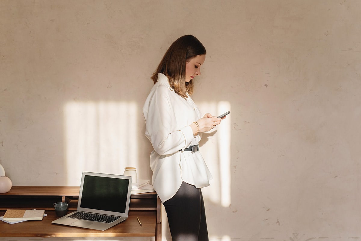 Woman texting with slight smile