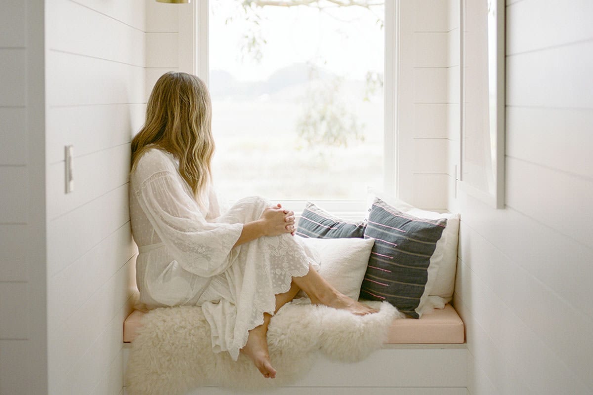 Self Care isn't selfish | Woman sitting on windowseat looking outside