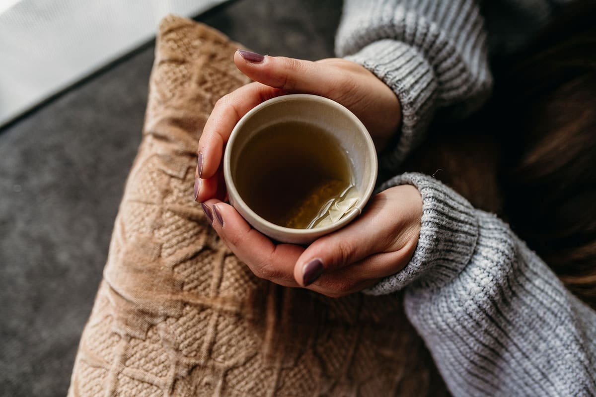 Self Care isn't Selfish | Woman holding cup of tea