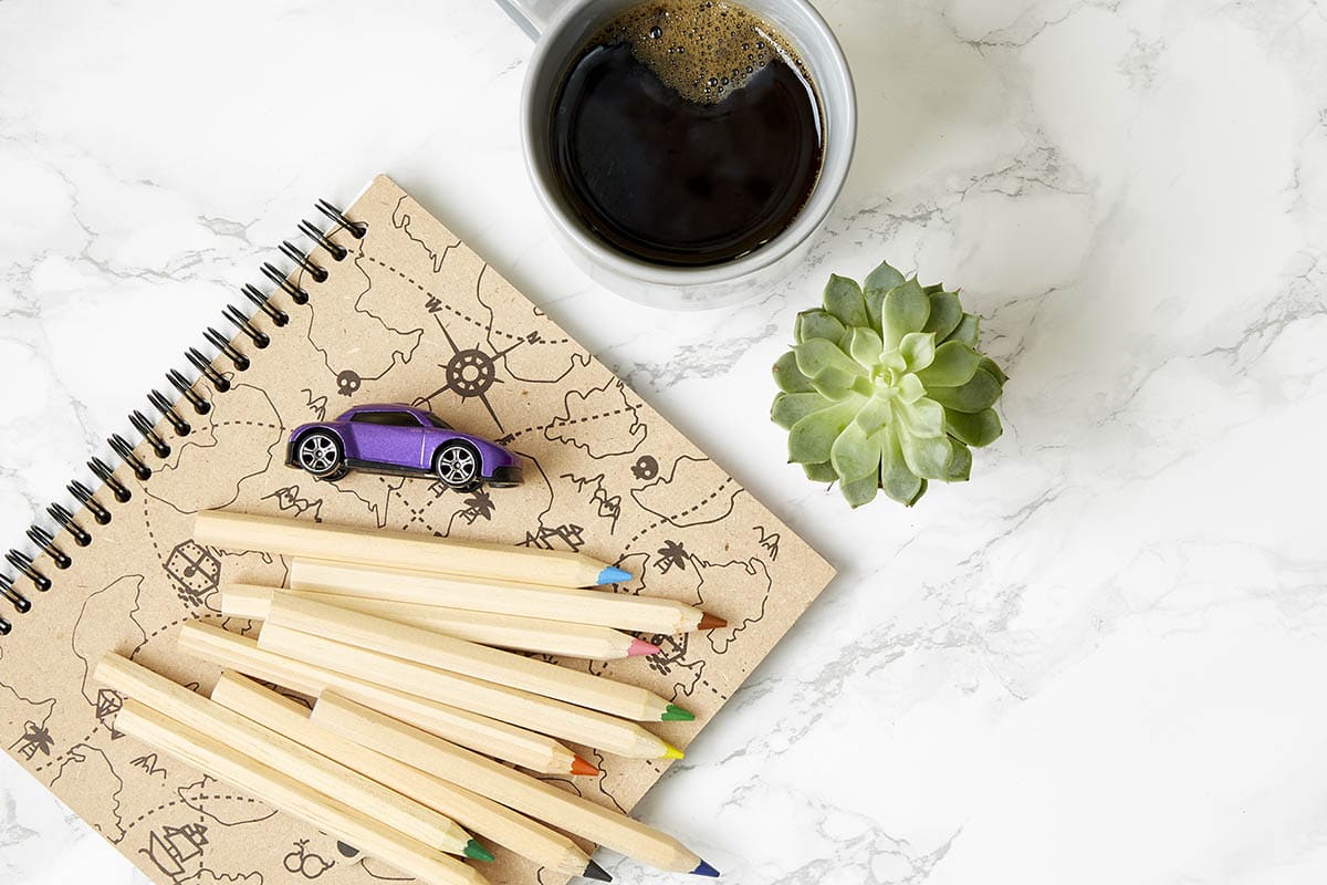 Family Staycation 3 - Colored pencils, notebook, toy car and cup of coffee