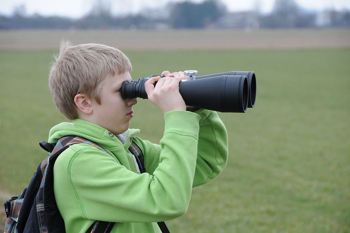 Family Staycation 9 - Boy using binoculars outside in a field