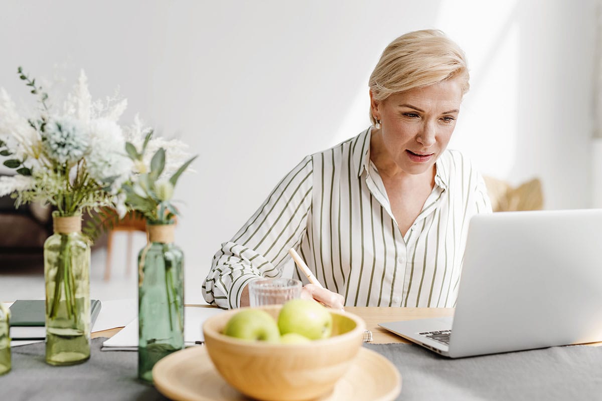 Middle-aged women working on laptop