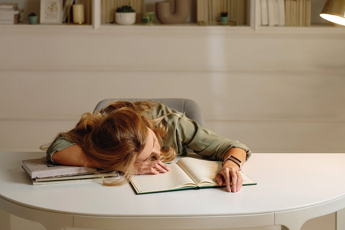 Lessons Career Break 3 | Woman laying her head on her desk