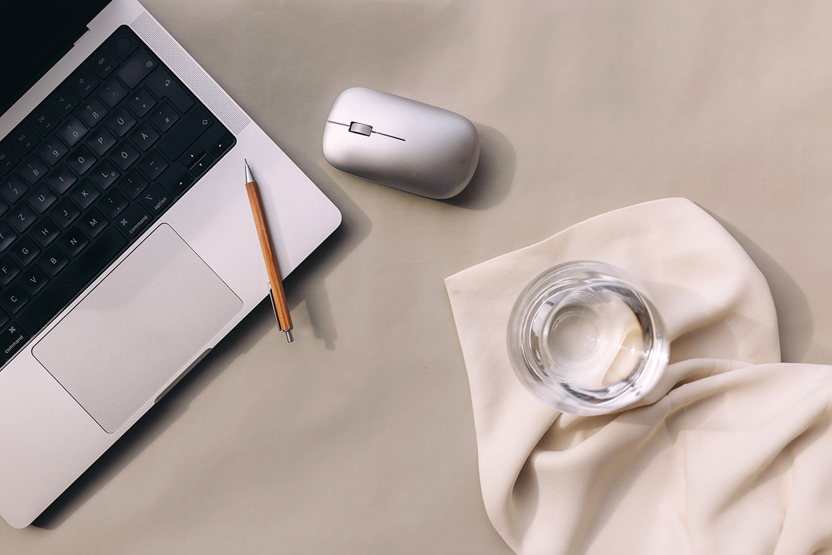 Laptop, mouse & glass of water