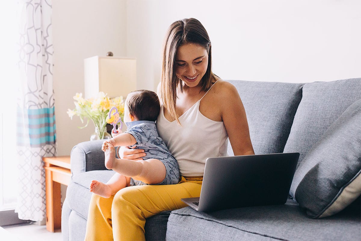 Empowering Womens Blogs 6 | Mom working on laptop with baby