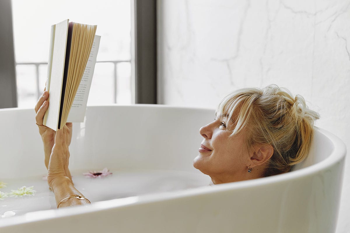 Monthly Routine 7 - Blond woman reading in a bathtub