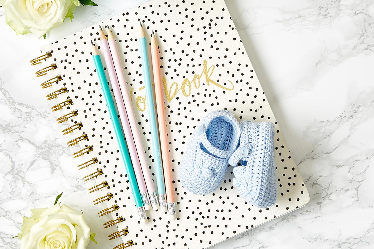 Journal, pens and boy baby booties