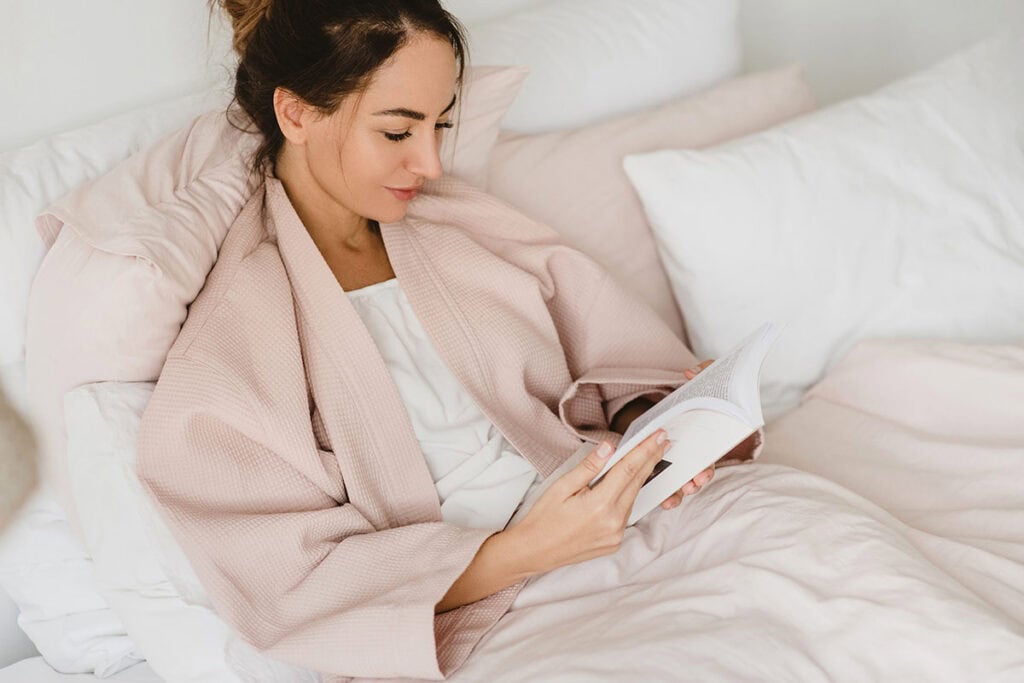 Woman reading in bed