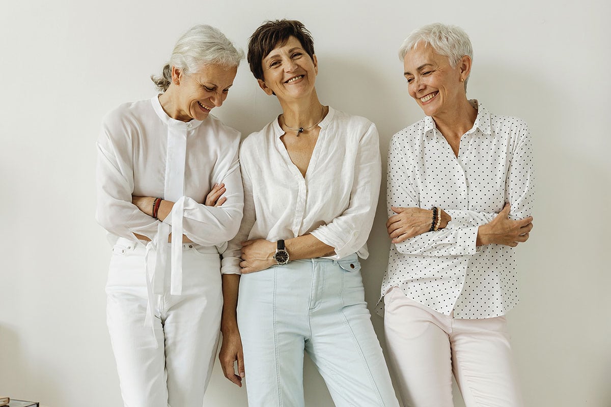 3 middle-aged women smiling together