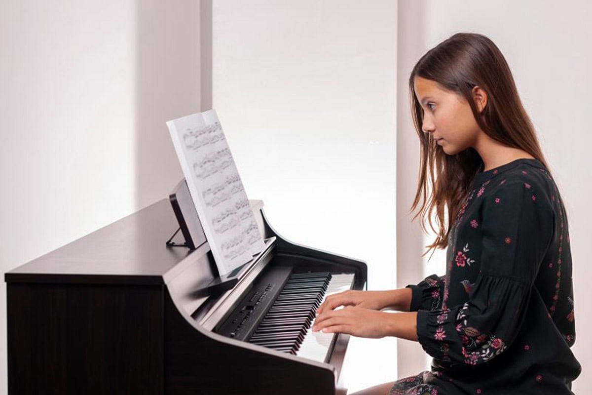 Tween girl playing piano