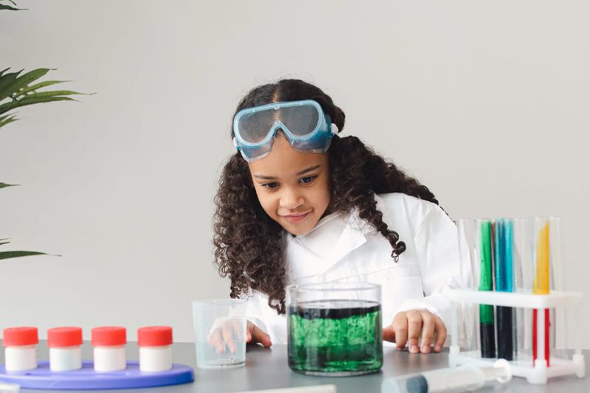 Girl with dark curly hair conducting science experiment