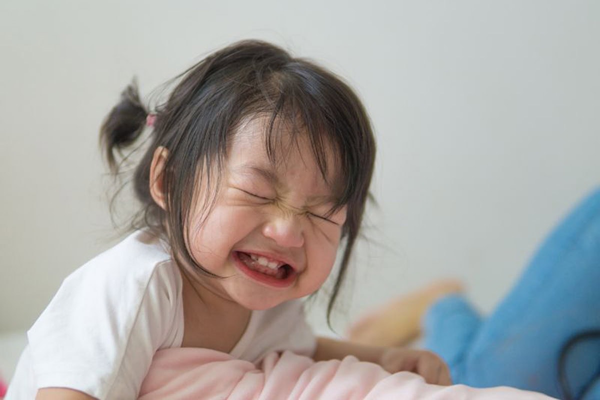 Young girl smiling a big goofy grin