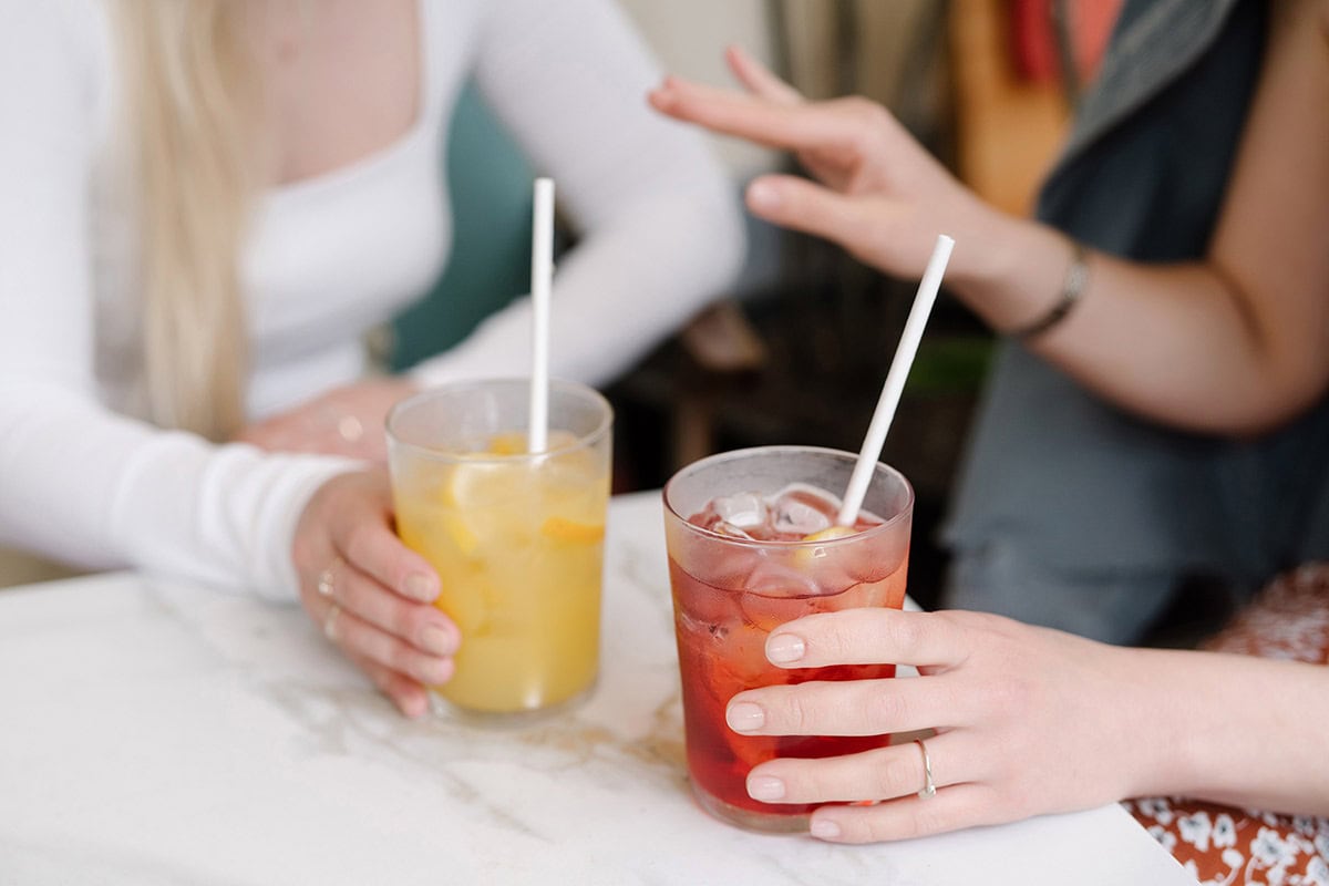 Two women chatting over drinks