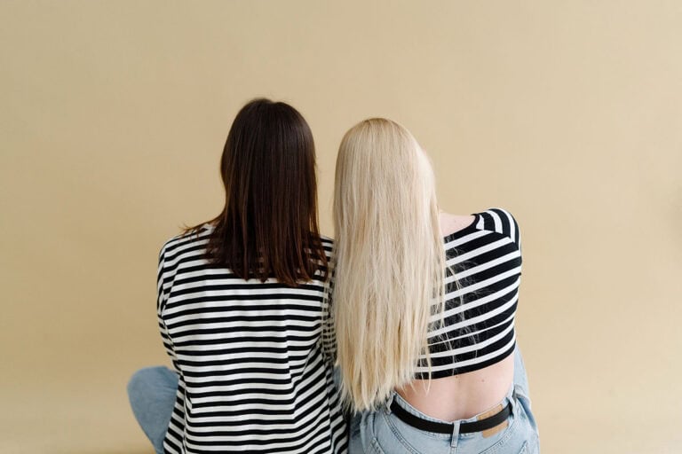 Adult Friendships are Hard | Two Women leaning on each other against neutral background