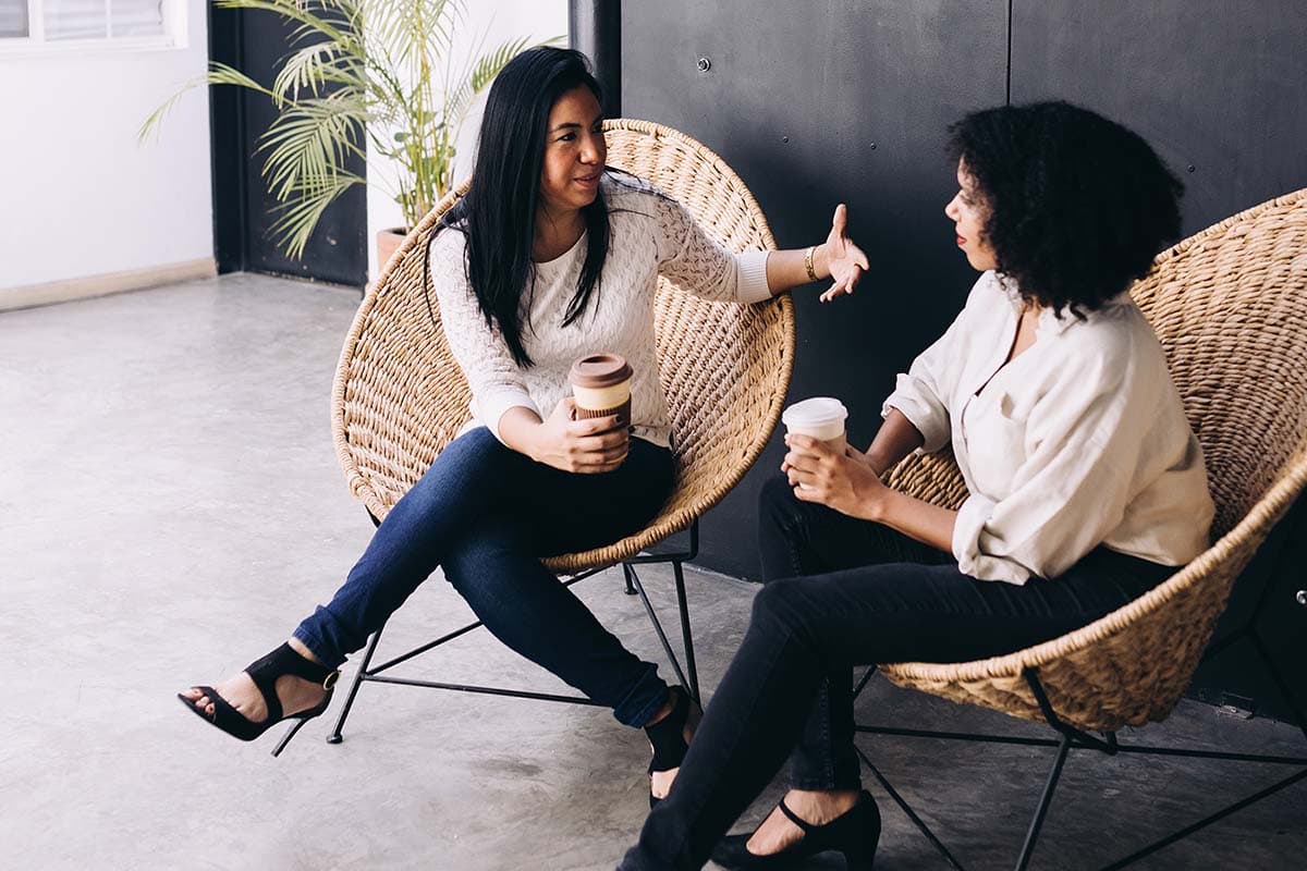 Two women chatting over coffee