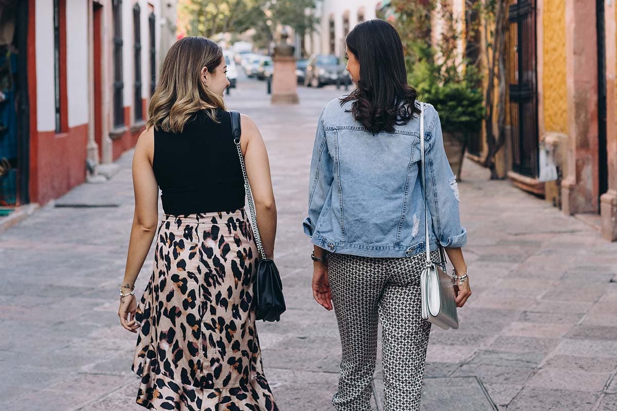 Two women walking down a street